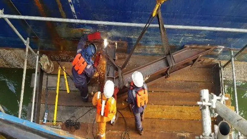 Offshore deck crew rigging and fabricating steelwork aboard a heavy lift vessel